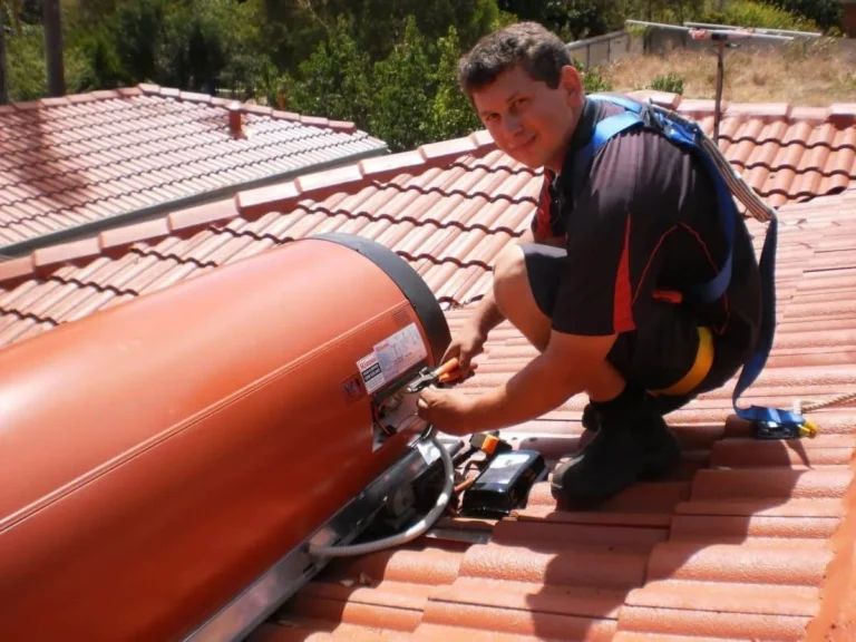 Kalamunda Plumbing technician working on a rooftop solar hot water tank